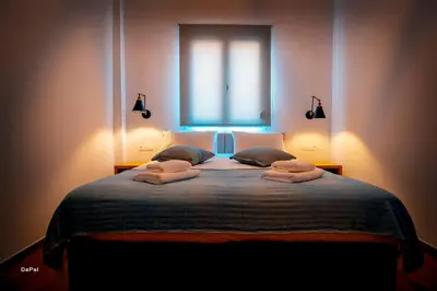 a bedroom with a bed with two pillows and a window at Bitsakis Family I - Paleochora Luxury House in Palaiochóra