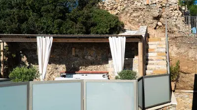 a house with white curtains in front of a building at Arhondiko Luxury House in Sougia