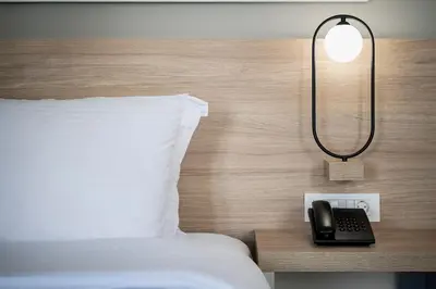 a bed with a lamp and a phone on a table at Epavli Boutique Hotel in Chania Town