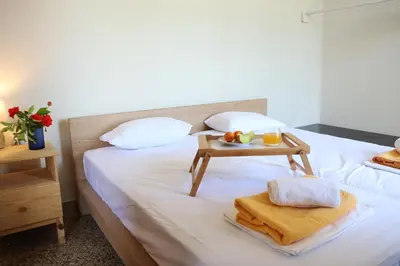 a hotel room with a bed with a tray of food on it at house in the village near the sea in Maleme