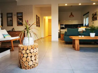 a living room with a wooden stump with a plant on it at Villa Patroklos in Daratso