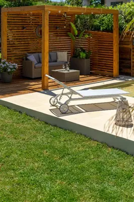 a patio with a couch and a table in a yard at Chania Elite Homes, Enjoy a Chic Oasis by the heated Pool in Kounoupidhianá