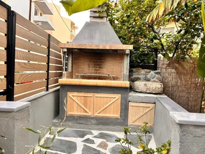 a brick oven with wooden doors on a wall at Evis House in Chania Town