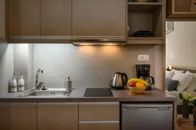 a kitchen with a sink and a bowl of fruit on the counter at Penny's Old Town Houses in Chania Town