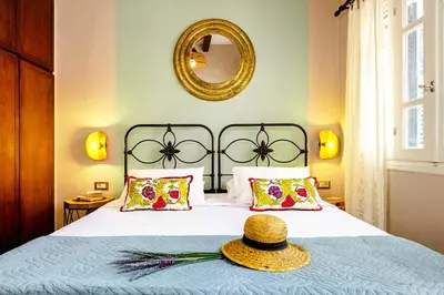 a bedroom with a bed with a hat on it at Chanialiving Venetian Luxury House-near Plaza Parking in Chania Town
