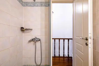 a bathroom with a shower with a glass door at Chanialiving Venetian Luxury House-near Plaza Parking in Chania Town