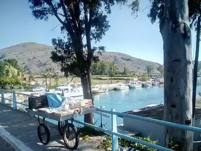 a bike parked next to a fence next to a river at Manolo s olive farm, apartment with seaview in Chania Town