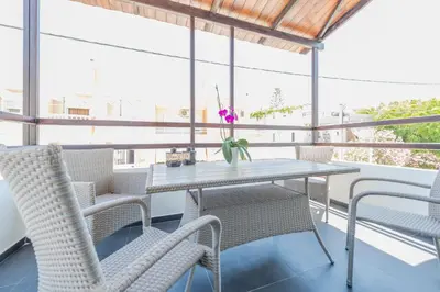 a table and chairs on a balcony with a view at Rotunda Suites in Kalamaki Chanion