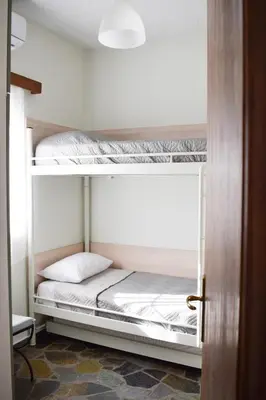 a bedroom with two bunk beds in a room at Elia's House Traditional & Cozy by 8essentially in Kalyves