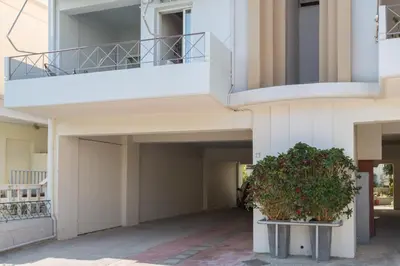 an apartment building with a balcony and a plant at Nautilus charm city center apt with veranda in Chania Town
