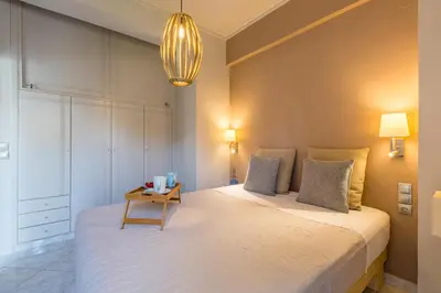 a bedroom with a large bed with a table on it at Nautilus charm city center apt with veranda in Chania Town