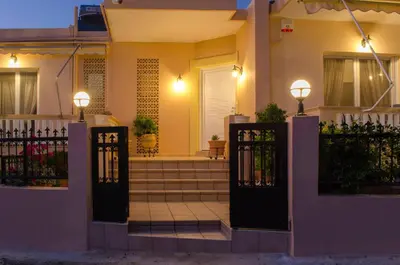a house with a front gate with lights on it at Villa Aretaki in Kalamaki Chanion