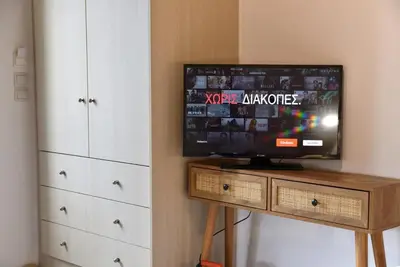 a tv sitting on a wooden table in a room at House near Balos in Kissamos in Kissamos