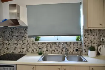 a kitchen counter with a sink and a window at House near Balos in Kissamos in Kissamos