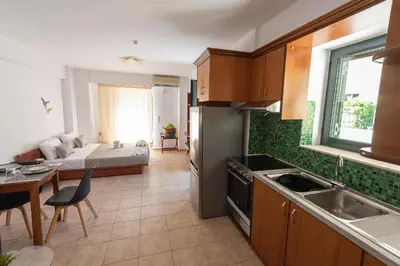 a kitchen and living room with a bed in the background at Camara Studios in Chania Town