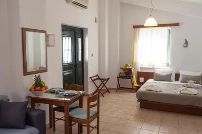 a living room with a bed and a table and a room at Camara Studios in Chania Town