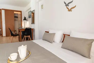 a bedroom with a bed with a tray on it at Camara Studios in Chania Town