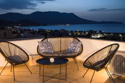 three chairs and a table on a balcony at Anastellar in Kissamos
