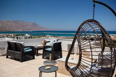 a patio with chairs and a swing at Anastellar in Kissamos
