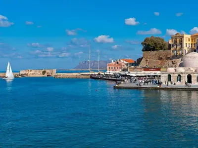 a body of water with a sail boat in the water at Metropolis House in Chania Town