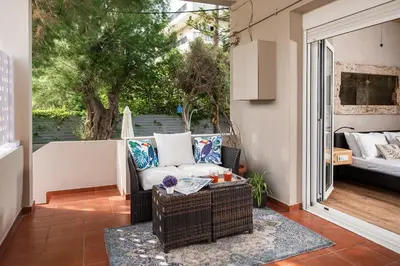 a patio with a couch and a table at Domus Aqua in Kato Daratso