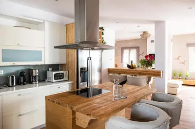 a kitchen with a wooden table and some chairs at Domus Aqua in Kato Daratso