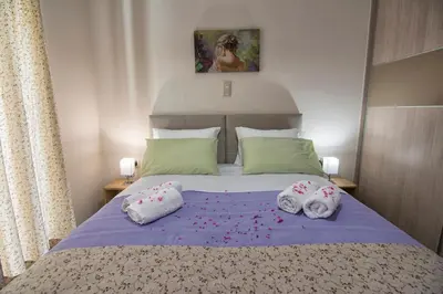 a bedroom with a bed with towels on it at Pasiphae New Apartment sea & city in Chania Town