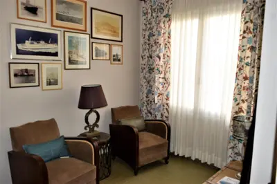 a living room with two chairs and a window at Casa Armada in Chania Town