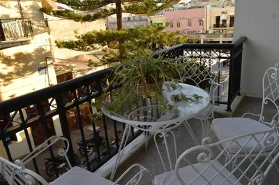 a table and chairs on a balcony with plants at Casa Armada in Chania Town