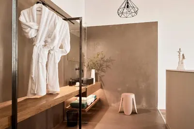 a bathroom with a white robe hanging on a shower stall at Villa Fuerte & Weddings Estate in Alikianós