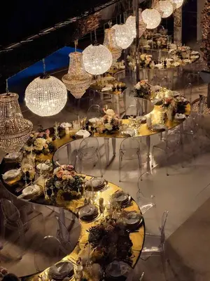 a room filled with tables with flowers and chandeliers at Villa Fuerte & Weddings Estate in Alikianós