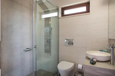 a bathroom with a shower and a toilet and a sink at Doro Villas in Kissamos