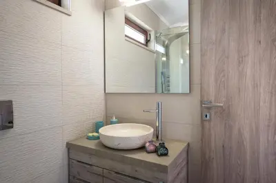 a bathroom with a sink and a mirror at Doro Villas in Kissamos