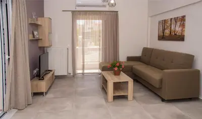 a living room with a couch and a table at Tonia's Apartment in Kissamos