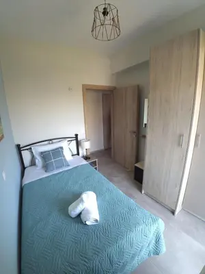 a bedroom with a bed with a towel on it at Tonia's Apartment in Kissamos