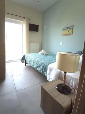 a bedroom with a bed and a lamp on a table at Tonia's Apartment in Kissamos