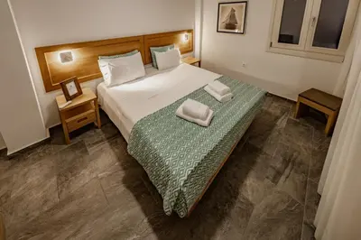 a bedroom with a bed with two towels on it at Chrisi Holiday Home - 500 sqm Private Gardens & Nature View - 300m by the sea in Almirida