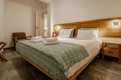 a bedroom with a large bed with two towels on it at Chrisi Holiday Home - 500 sqm Private Gardens & Nature View - 300m by the sea in Almirida