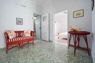 a living room with a couch and a table and a bed at House on the sea near Chania in Galatás