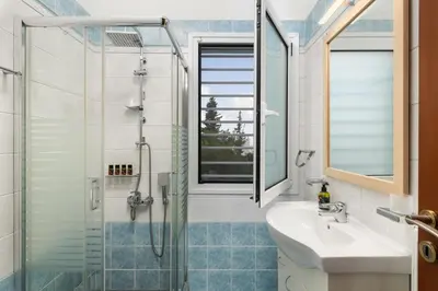 a bathroom with a sink and a shower at Cedar Tree Villa in Kounoupidhianá