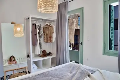 a bedroom with a dresser and a girl in a room at Old town, Splantzia modern house in Chania Town