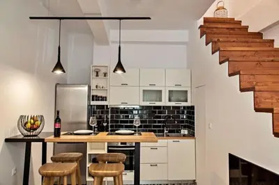 a kitchen with a table and some chairs and a staircase at Old town, Splantzia modern house in Chania Town