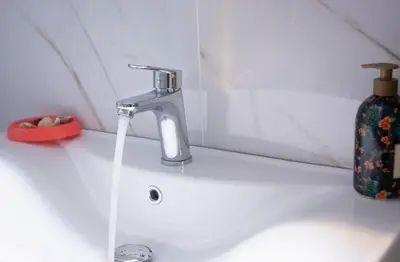 a sink with a faucet and a bottle of soap at Marial City Apartment Chania in Chania Town