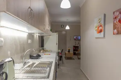a kitchen with a sink and a counter top at Marial City Apartment Chania in Chania Town