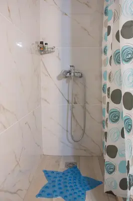 a bathroom with a shower with a blue star on the floor at Marial City Apartment Chania in Chania Town