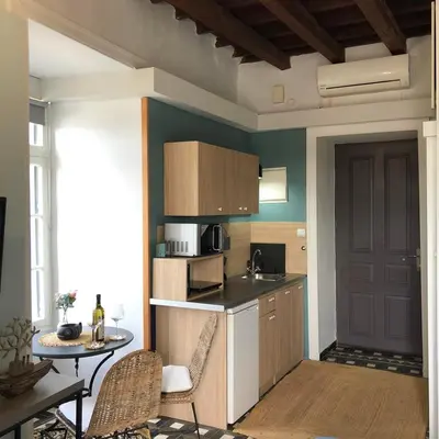 a small kitchen with a table and a table and chairs at Old Port - Bellavista Studio in Chania Town