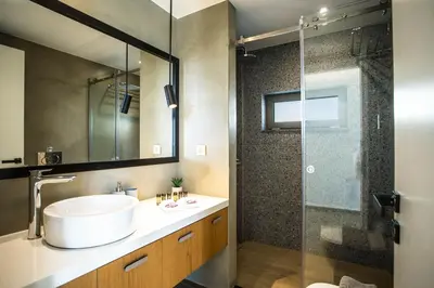 a bathroom with a sink and a glass shower at Villa Aori in Kariá