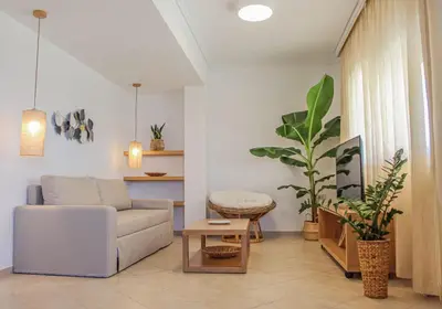 a living room with a couch and a table at Endless Blue in Palaiochóra