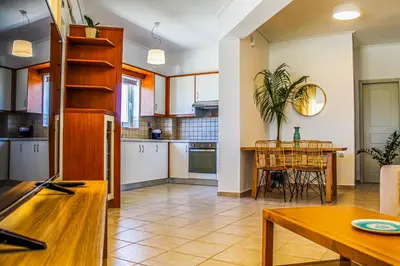 a kitchen with a table and a dining room at Endless Blue in Palaiochóra
