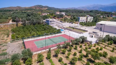 an overhead view of a tennis court with a tennis at Queen Electra with pool and tennis court in Alikianós